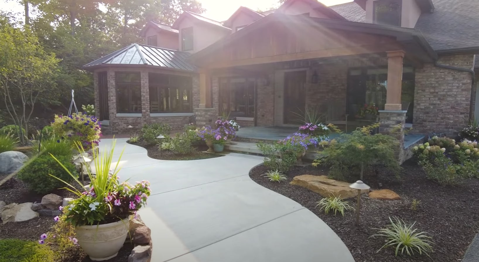 Professional Residential Landscape Design with Hardscaping Beautiful residential landscape with professional hardscaping featuring curved walkways, decorative planters, and mature landscaping in Dunwoody, GA