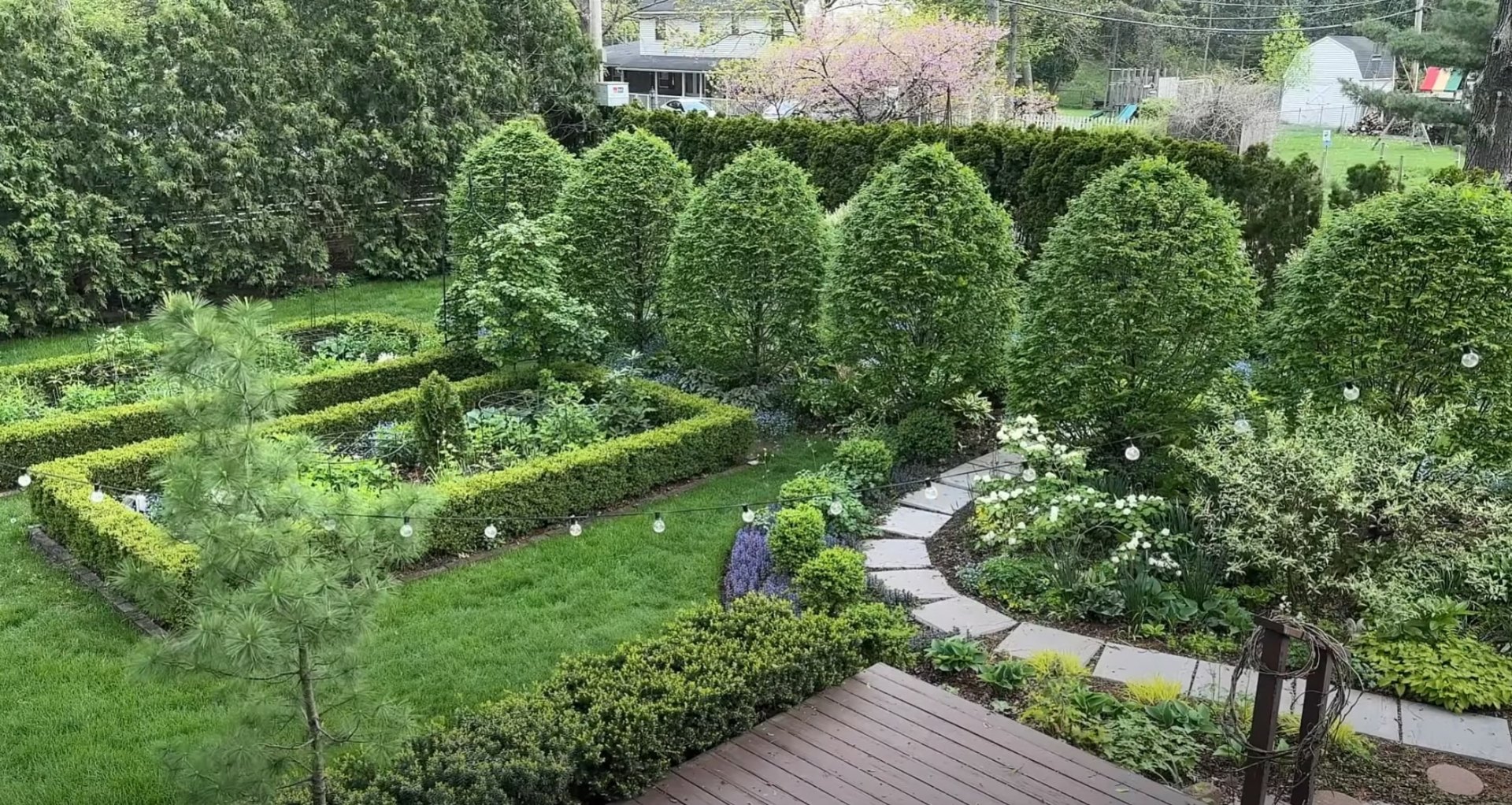 Formal Landscape Design with Lighting and Maintenance Formal garden design with geometric landscaping, professional lawn care, ornamental lighting, and structured plant arrangements